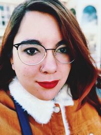Close-up portrait of smiling young woman