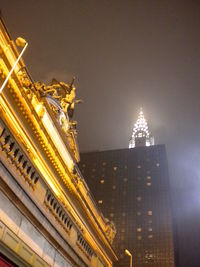 Low angle view of illuminated tower at night