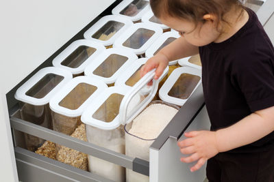 Child picking an item from storage hutch. smart kitchen organization concept