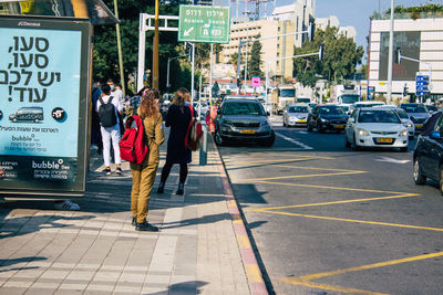 People walking on road in city