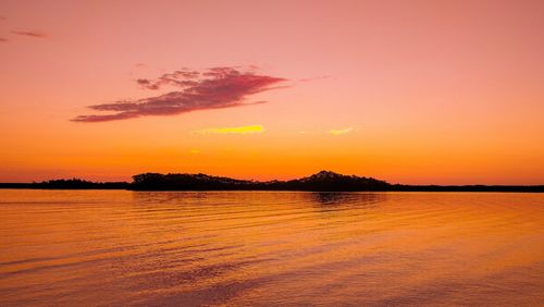 Scenic view of sea against romantic sky at sunset