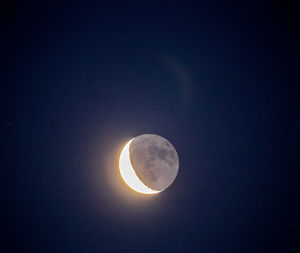 Low angle view of moon against sky at night