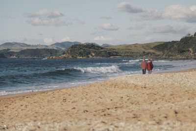 Man on beach against sky