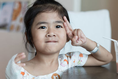 Cute girl gesturing at hospital