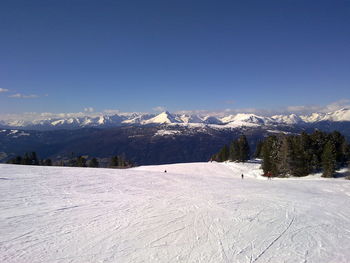 Scenic view of snow covered mountains against clear sky