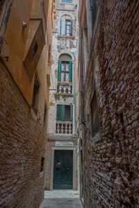Narrow alley amidst buildings in city