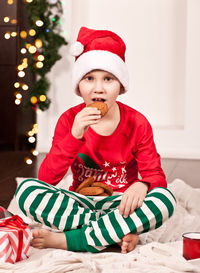 Portrait of cute girl sitting on table