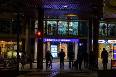 People walking in illuminated city