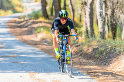 Man riding bicycle on road