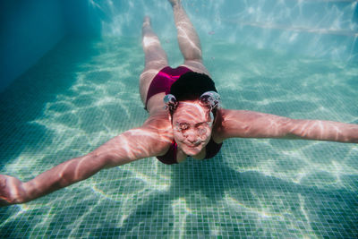 Portrait of woman swimming in pool