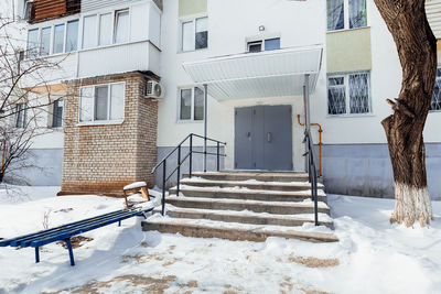 Entrance of a multi-storey residential building in winte