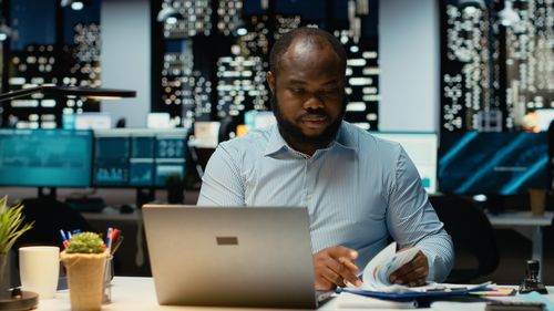 Young man using laptop at cafe