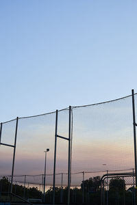 Low angle view of chainlink fence against clear sky