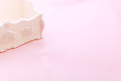 Close-up of heart shape over pink background