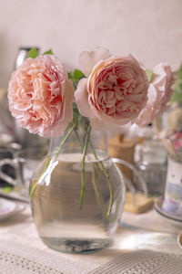Close-up of roses in glass vase on table