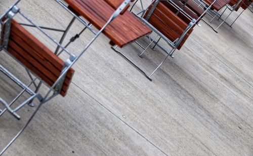 High angle view of empty chairs on wooden floor