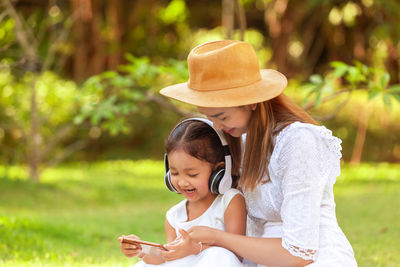 Mother and girl with daughter outdoors