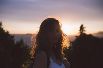 Portrait of woman against sky during sunset