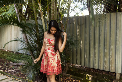 Woman standing against bamboo grooves