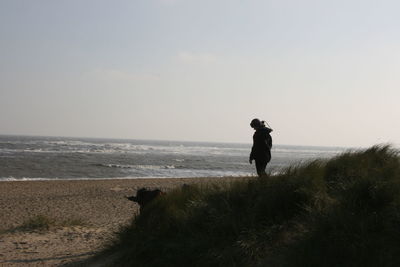 Rear view of man standing on beach