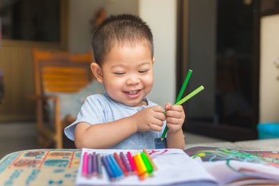 Boy drawing on table at home