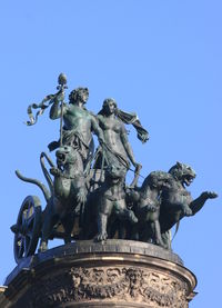 Low angle view of statue against clear blue sky