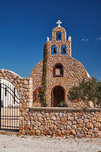 Low angle view of historic building against clear blue sky