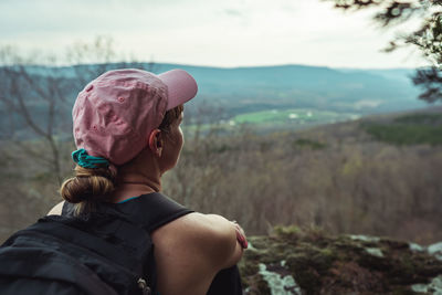 Rear view of woman in hat against sky