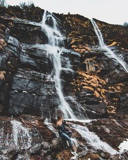 Scenic view of waterfall against sky