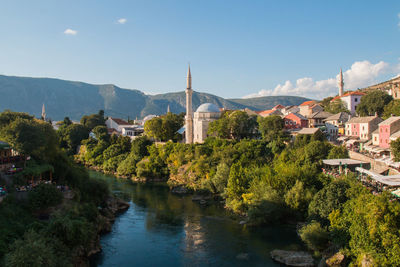 Panoramic view of river amidst buildings against sky