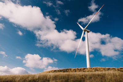 Windmill on field against sky