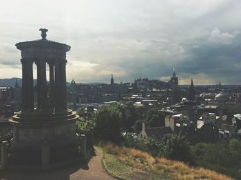 View of cityscape against cloudy sky