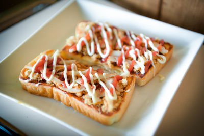 High angle view of pizza in plate on table