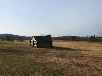 Built structure on field against sky