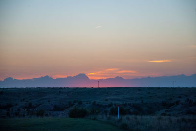 Scenic view of field against sky during sunset