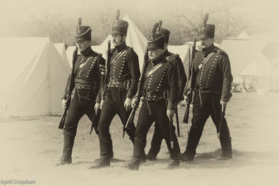 Full length of men standing on field