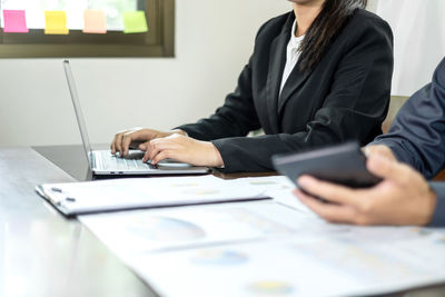 Midsection of business colleagues working at office