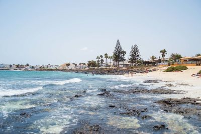 Scenic view of beach against clear sky