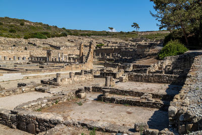 Old ruins in city against clear sky