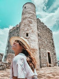 Woman standing against built structure