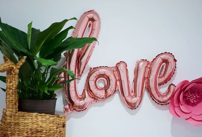 Close-up of red chili peppers on table against white background