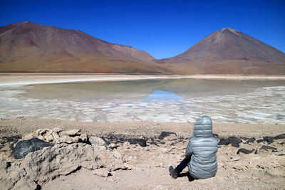 Scenic view of rocks against clear blue sky