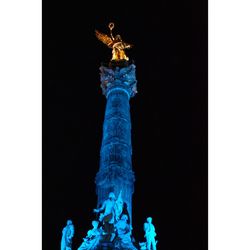 Low angle view of statue against blue sky