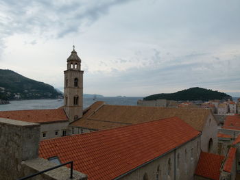 Church by sea against sky in old town