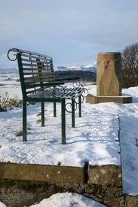 Gazebo in snow against sky during winter