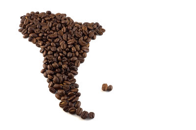 Close-up of coffee beans against white background