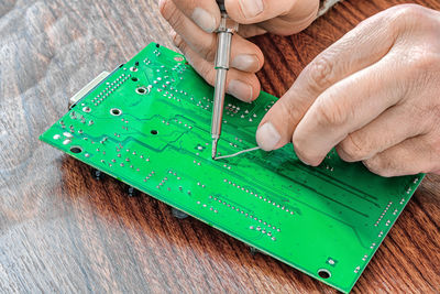 Cropped hand holding thermometer