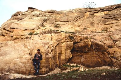 Full length of man standing on rock