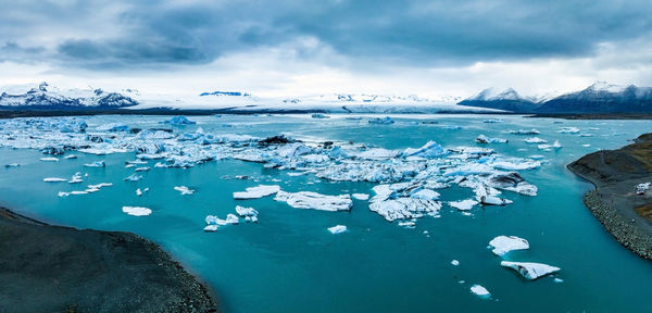 Scenic view of icebergs in jokulsarlon glacier lagoon, iceland, at dusk.