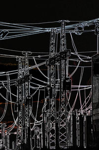 Close-up of illuminated communications tower against black background